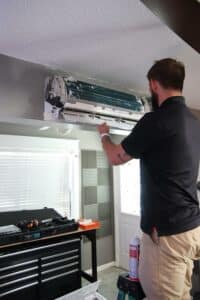 Service Emperor tech working on an HVAC System Maintenance  residential ac unit